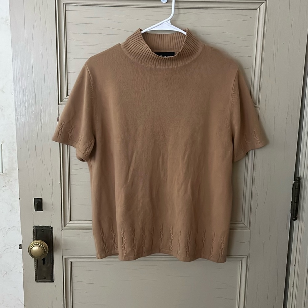 Tan tee shirt with high neck.